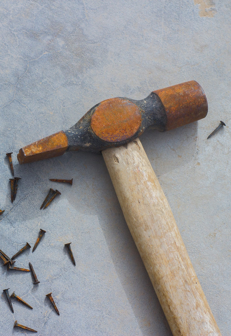 A rusty hammer and nails
