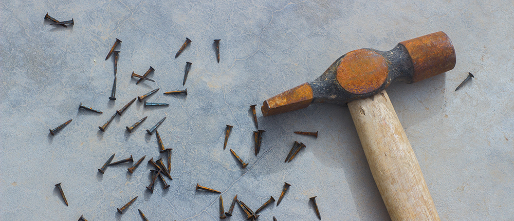 A rusty hammer and nails