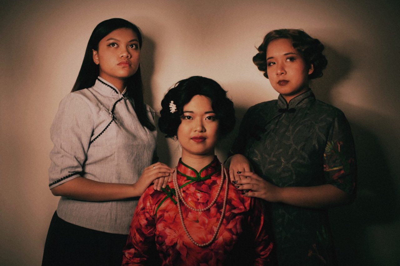 three people in a formal portrait in formal clothes