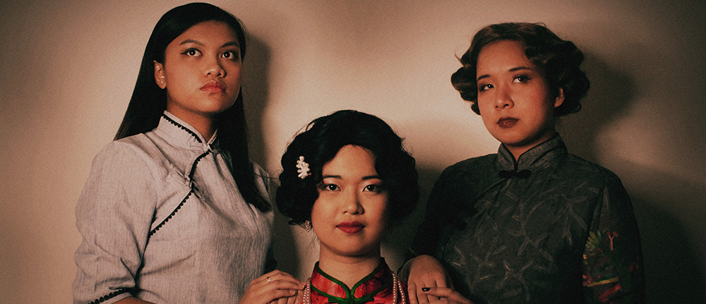 A portrait with three people in formal wear
