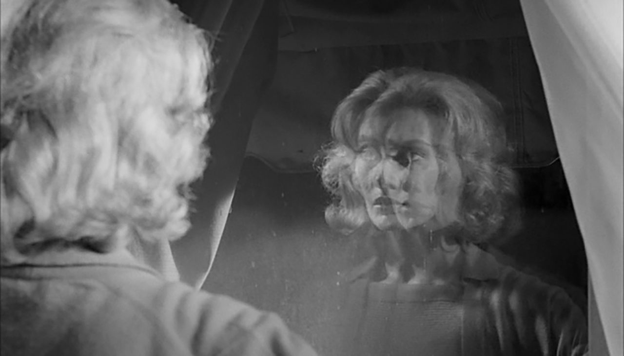 A blurry reflection of a womens face