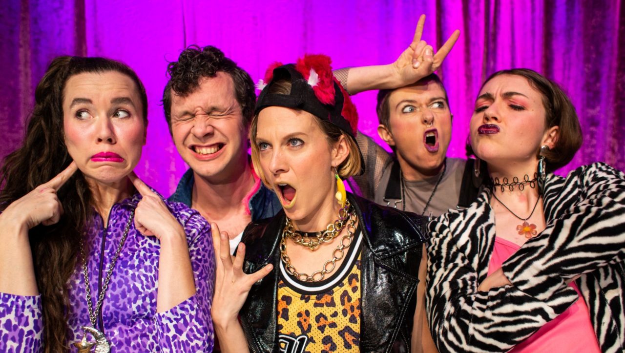 five people pulling faces with bright and patterned costumes on