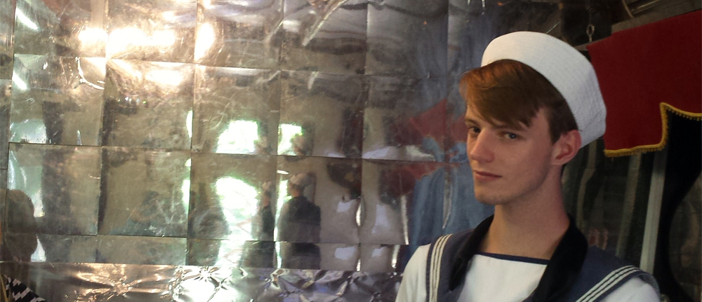 Young man in sailor suit in Venetian interior