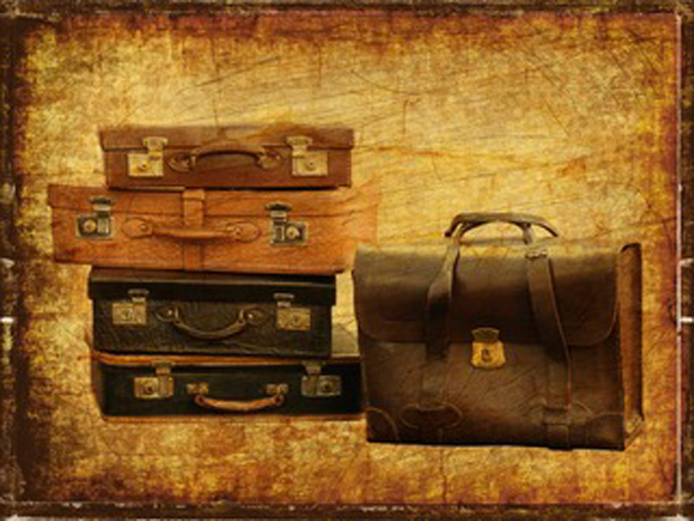 A stack of suitcases on a brown background