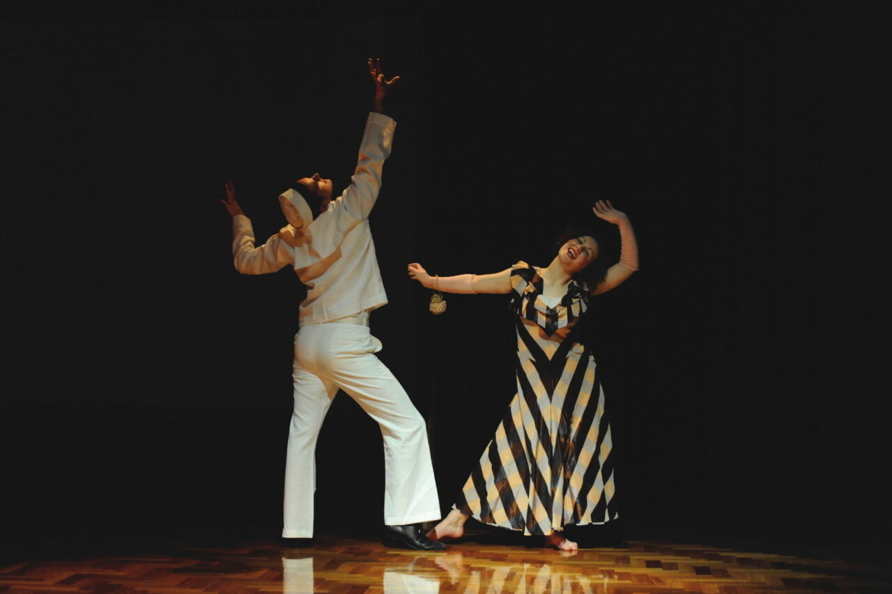 A young woman and an American sailor dance the Jitterbug.