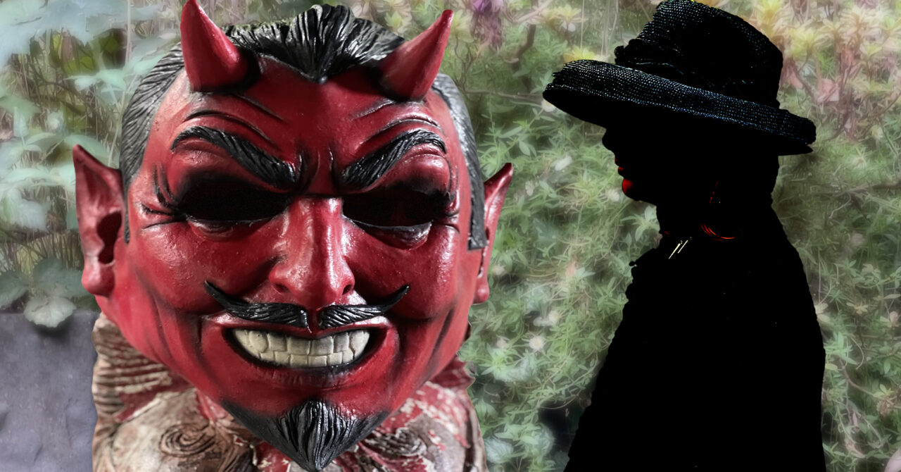 A red devil mask in foreground and a woman in sillhouette against a rural backdrop.