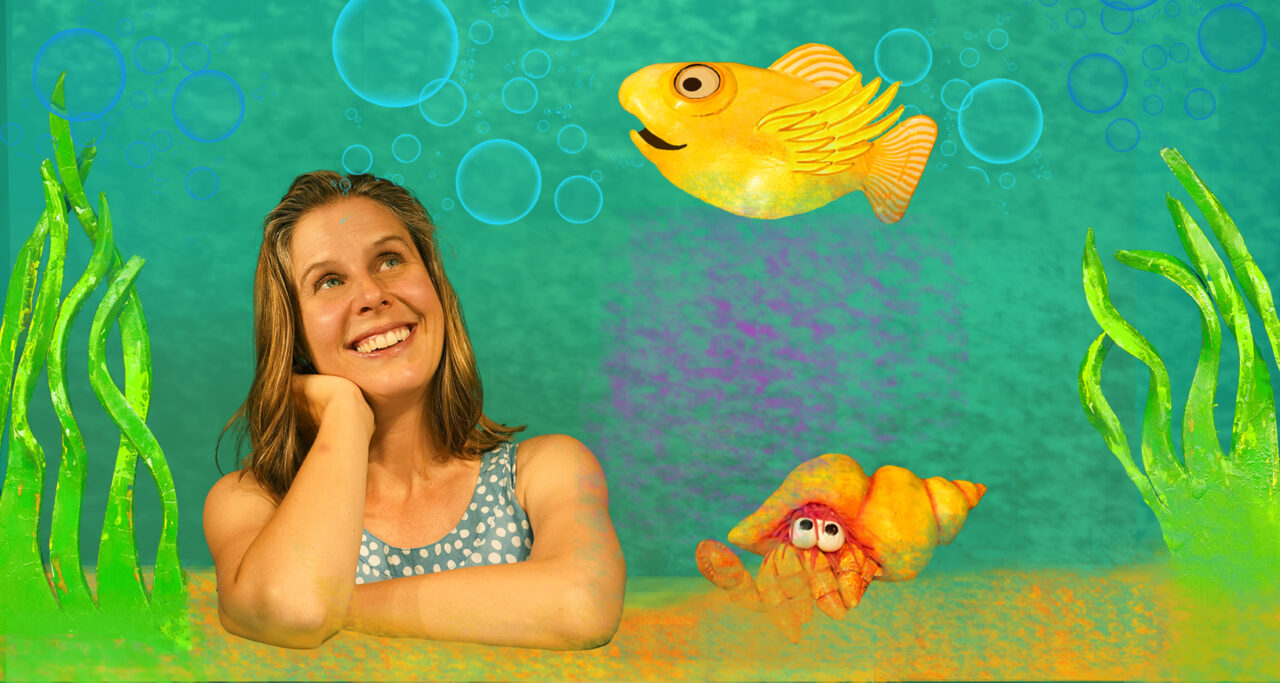 A woman looks up in wonder at a fish flying above her head.