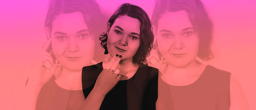 A woman with shoulder-length hair uses Auslan to sign “deaf” and “flat”