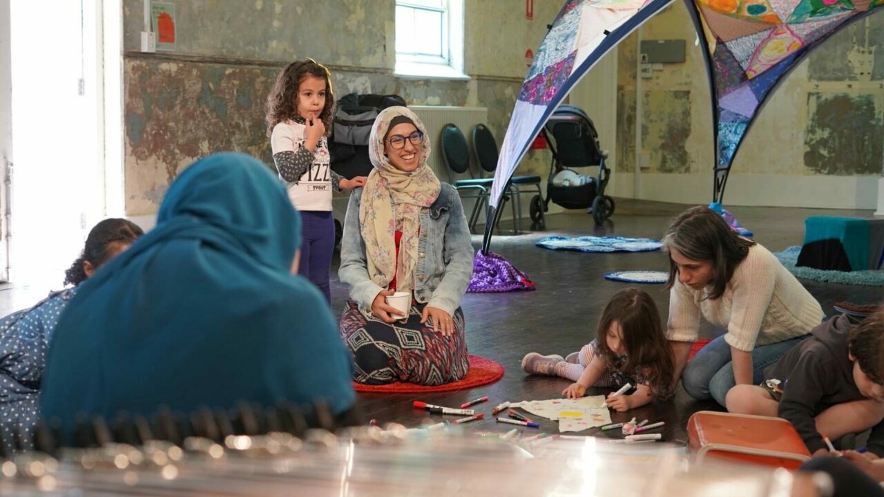 a woman in a hijab surrounded by children